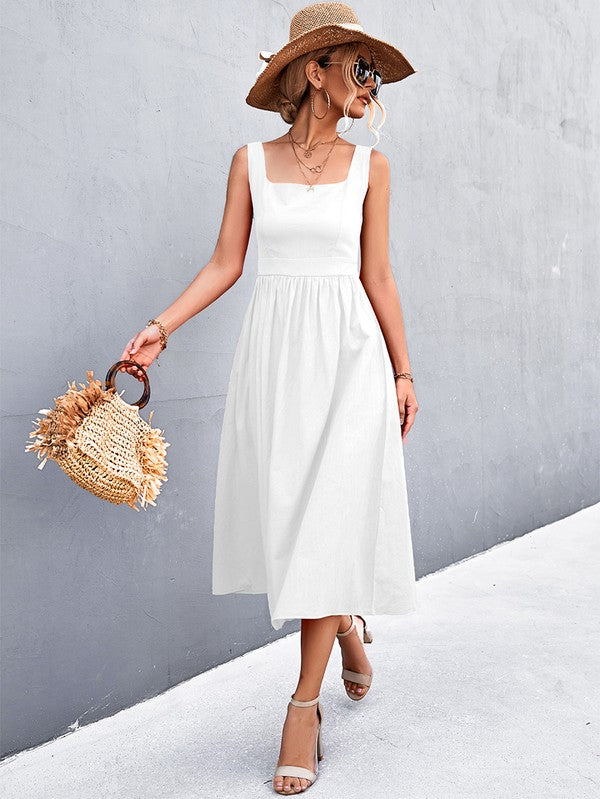 A woman in a Women's Sleeve Less Dress, featuring a vibrant red hue and crafted from 100% polyester, stands against a gray wall. She accessorizes with a wide-brimmed hat, holds a straw handbag, and complements her outfit with beige sandals.