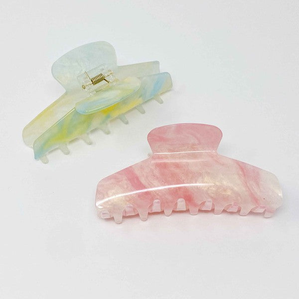 Two oversized capacity, Art Of Colors Hair Claw hair clips on a white background.