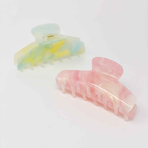 Two oversized capacity, Art Of Colors Hair Claw hair clips on a white background.
