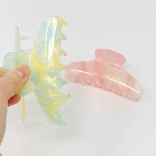 Two oversized capacity, Art Of Colors Hair Claw hair clips on a white background.