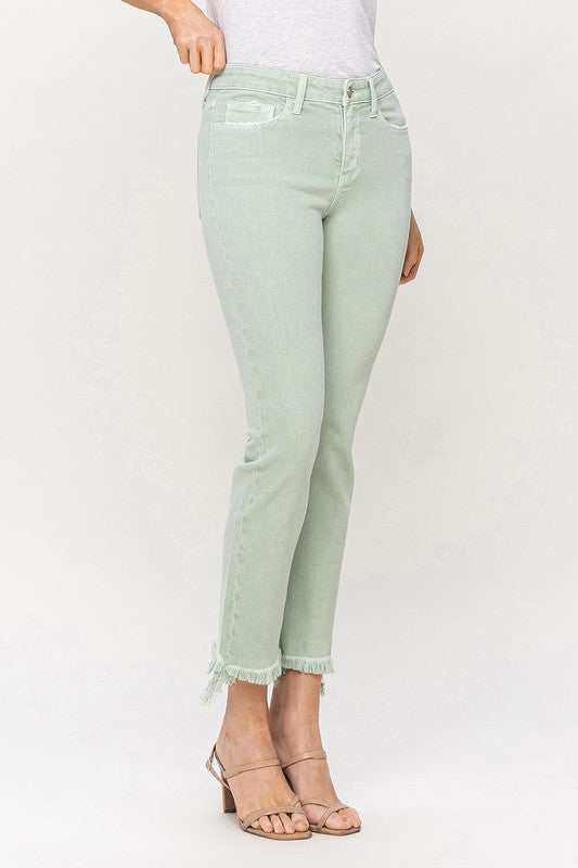 A model wearing Mid Rise Crop Straight Jeans in light green, featuring frayed hems, stands against a plain background, showcasing the jeans from waist to ankle.