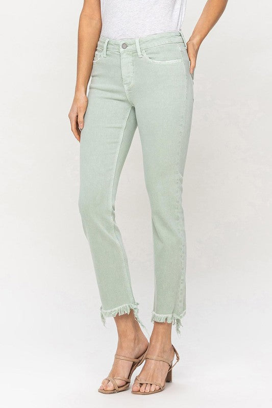 A model wearing Mid Rise Crop Straight Jeans in light green, featuring frayed hems, stands against a plain background, showcasing the jeans from waist to ankle.