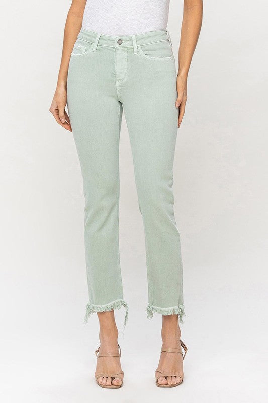 A model wearing Mid Rise Crop Straight Jeans in light green, featuring frayed hems, stands against a plain background, showcasing the jeans from waist to ankle.