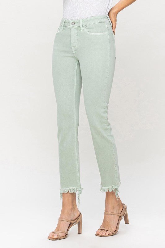 A model wearing Mid Rise Crop Straight Jeans in light green, featuring frayed hems, stands against a plain background, showcasing the jeans from waist to ankle.