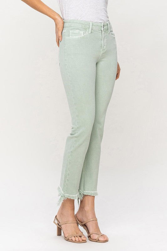 A model wearing Mid Rise Crop Straight Jeans in light green, featuring frayed hems, stands against a plain background, showcasing the jeans from waist to ankle.