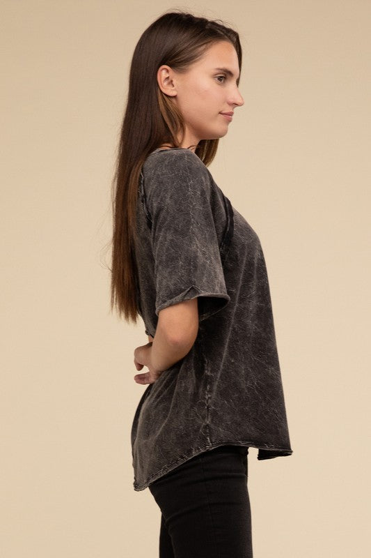 A person with long brown hair wearing a Back Patch Crinkle Washed Raglan Sleeve T-Shirt stands against a plain beige background.