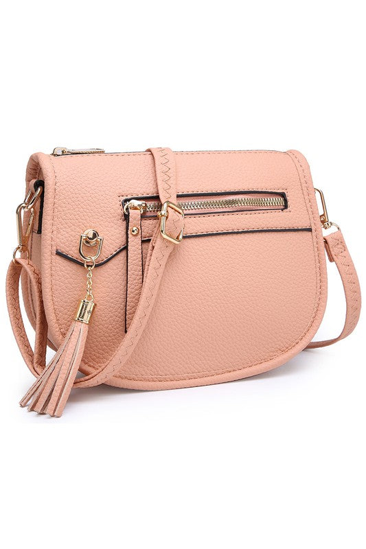 The Fashion Saddle Crossbody Bag in lavender faux vegan leather features a gold zipper, front pocket, tassel detail, and an adjustable shoulder strap.