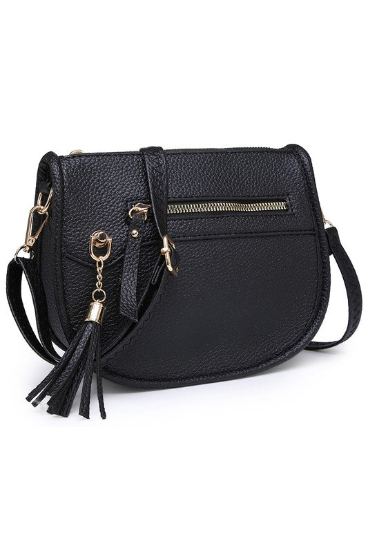 The Fashion Saddle Crossbody Bag in lavender faux vegan leather features a gold zipper, front pocket, tassel detail, and an adjustable shoulder strap.