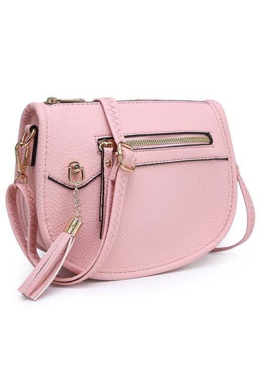 The Fashion Saddle Crossbody Bag in lavender faux vegan leather features a gold zipper, front pocket, tassel detail, and an adjustable shoulder strap.