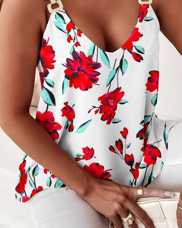 A woman wearing the Women Printed Tank TOP, featuring a blue and white V-neck design with metallic golden color trim, is seated with her hands resting on her legs.