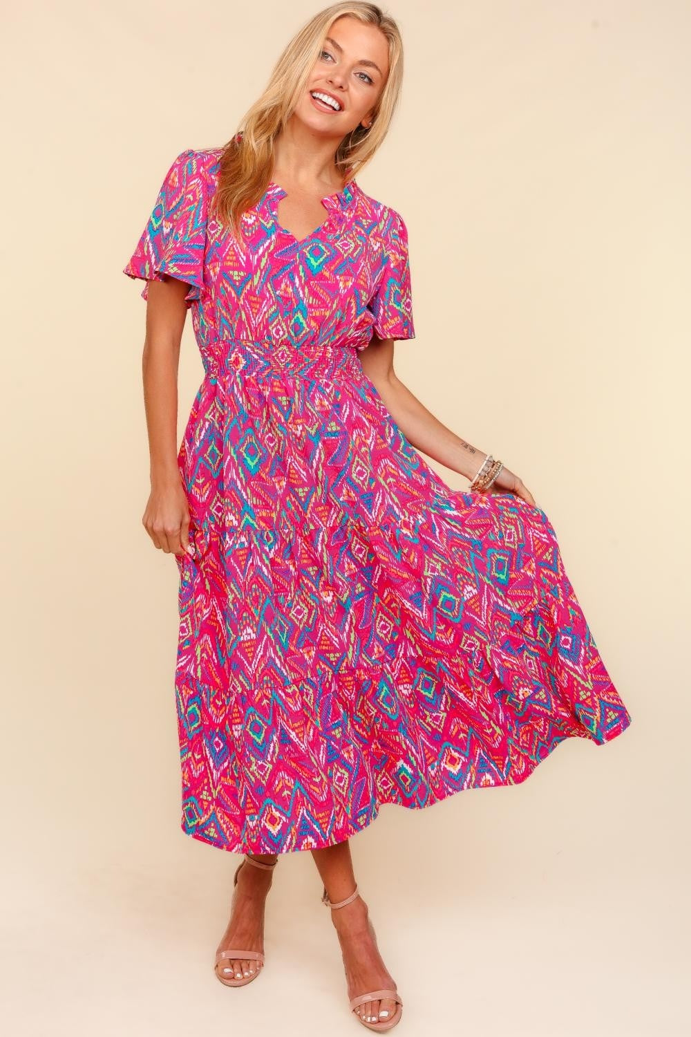 Person wearing the Haptics Abstract Print Smocked Waist Dress with Pockets, smiling with one hand on hip, exuding confidence and style.