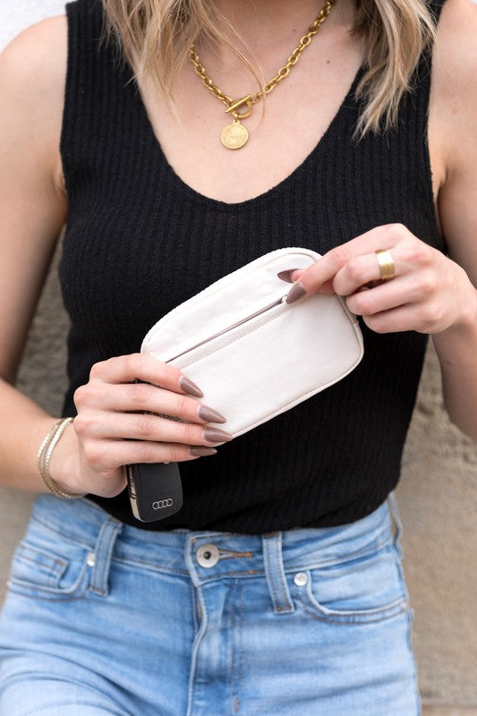 A person holds the Journey Clippable ID Wallet Pouch, featuring a sleek black design crafted from water-resistant nylon, with an ID card cleverly clipped and car keys securely attached.