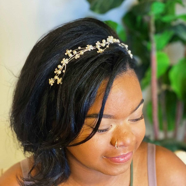 Artful Snow Flower Headband with pearls and crystals on a black marble background.