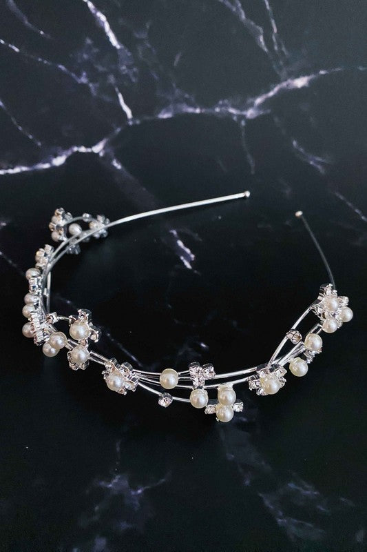 Artful Snow Flower Headband with pearls and crystals on a black marble background.