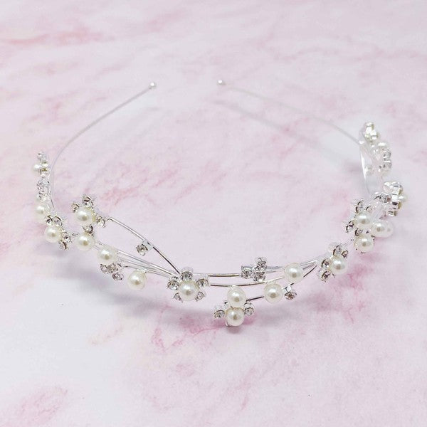 Artful Snow Flower Headband with pearls and crystals on a black marble background.