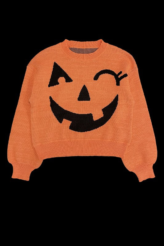 Pumpkin Halloween Sweater featuring an orange design with a winky jack-o'-lantern face on the front, set against a black background.