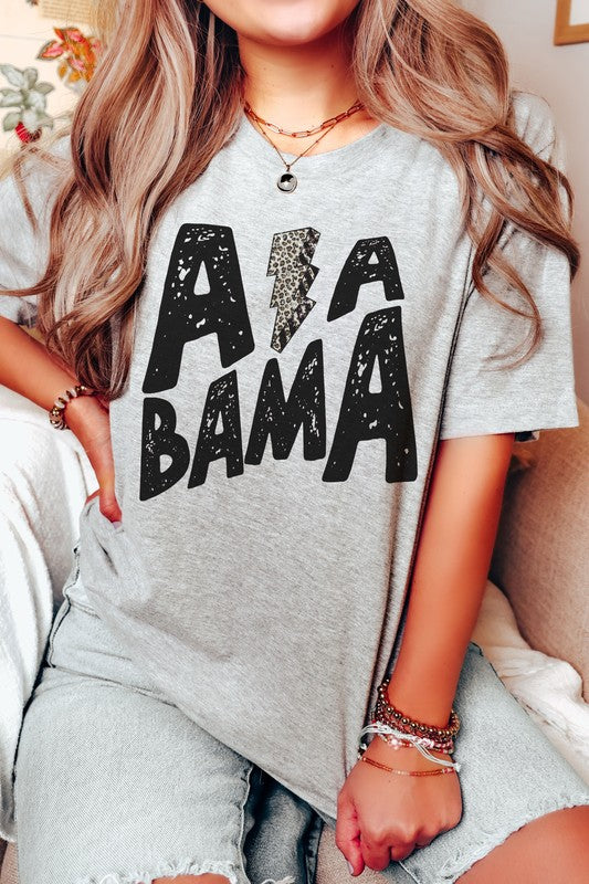 Person wearing the ALABAMA LEOPARD LIGHTNING GRAPHIC TEE, paired with distressed jeans.