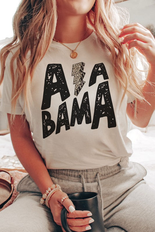 Person wearing the ALABAMA LEOPARD LIGHTNING GRAPHIC TEE, paired with distressed jeans.