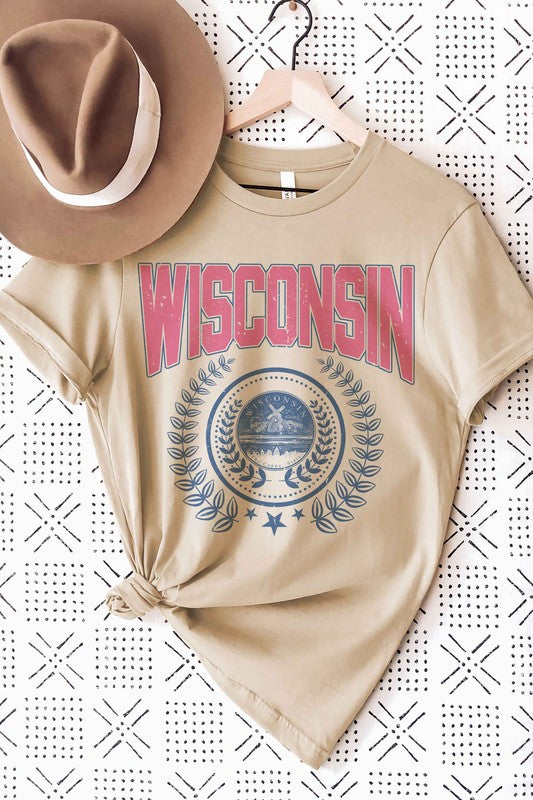 A person wearing a 100% cotton WISCONSIN GRAPHIC TEE, featuring the word "Wisconsin" in pink letters and a blue emblem with laurel wreaths underneath, designed for unisex sizing to fit everyone.