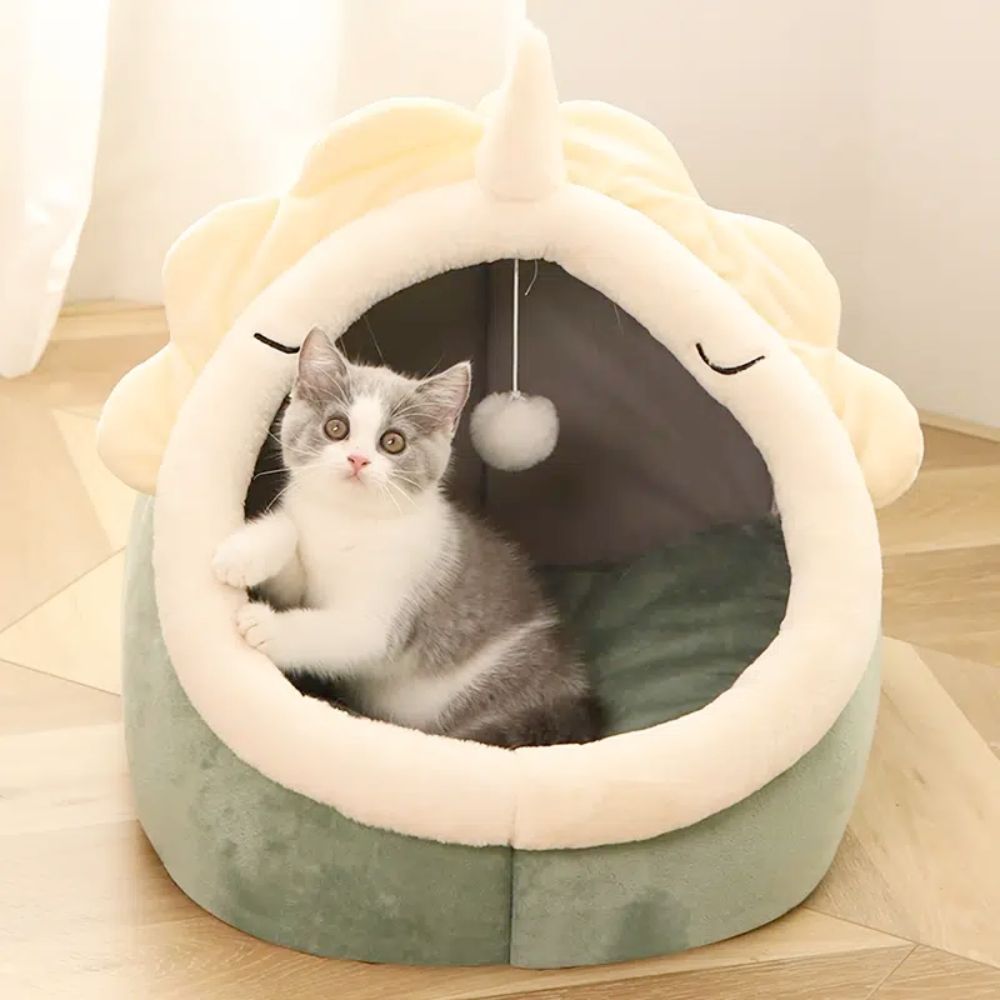 An Adorable Dinosaur Pet House with Toy has a toy unicorn for the cat to play with.