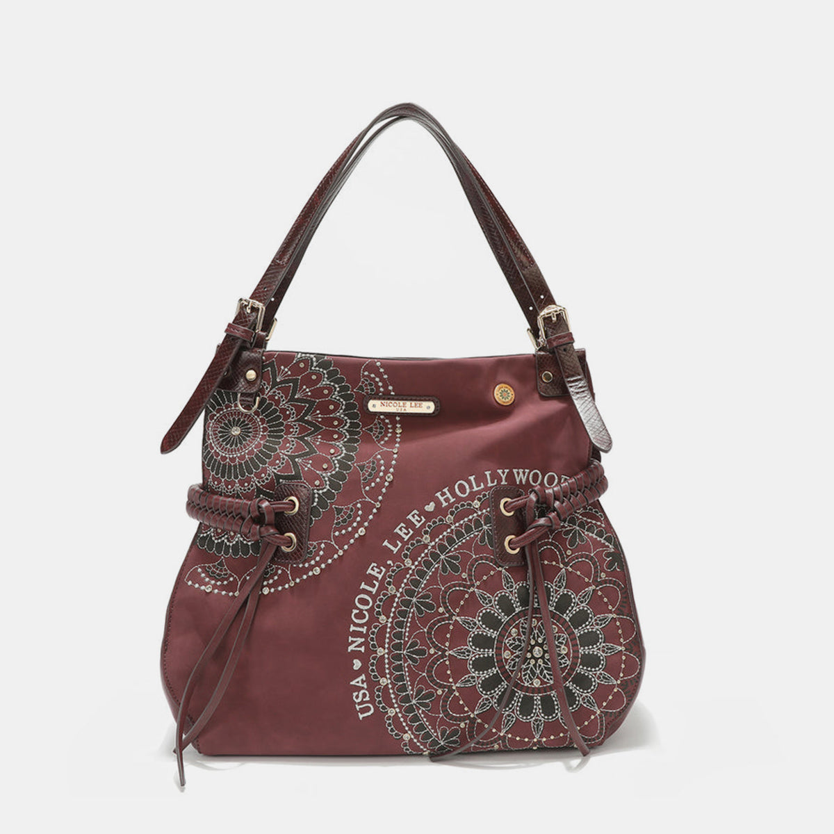 The Nicole Lee USA Side Braided Tassel Inlaid Rhinestone Embroidery Hobo Bag features intricately designed white mandala patterns on brown vegan leather, along with "Nicole Lee Hollywood USA" text. It includes top handles and decorative braided accents, as well as adjustable dual shoulder straps for added versatility.