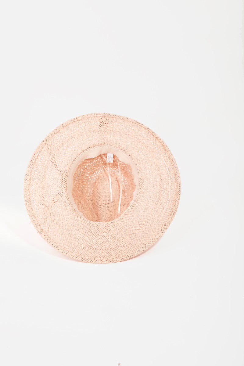 The Fame Braided Rope Straw Hat, in a charming pink color, is a perfect addition to your summer wardrobe. It features a wide brim and fringe detail around the crown, offering stylish sun protection against a light background.