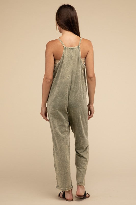 Woman standing and posing in a studio, wearing casual comfort style green Washed Spaghetti Straps Overalls with Pockets and sandals.