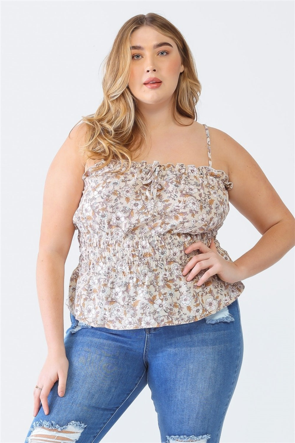 A person with long hair, wearing the Zenobia Plus Size Frill Floral Square Neck Cami and dark jeans, stands with one hand on their hip and the other relaxed by their side.