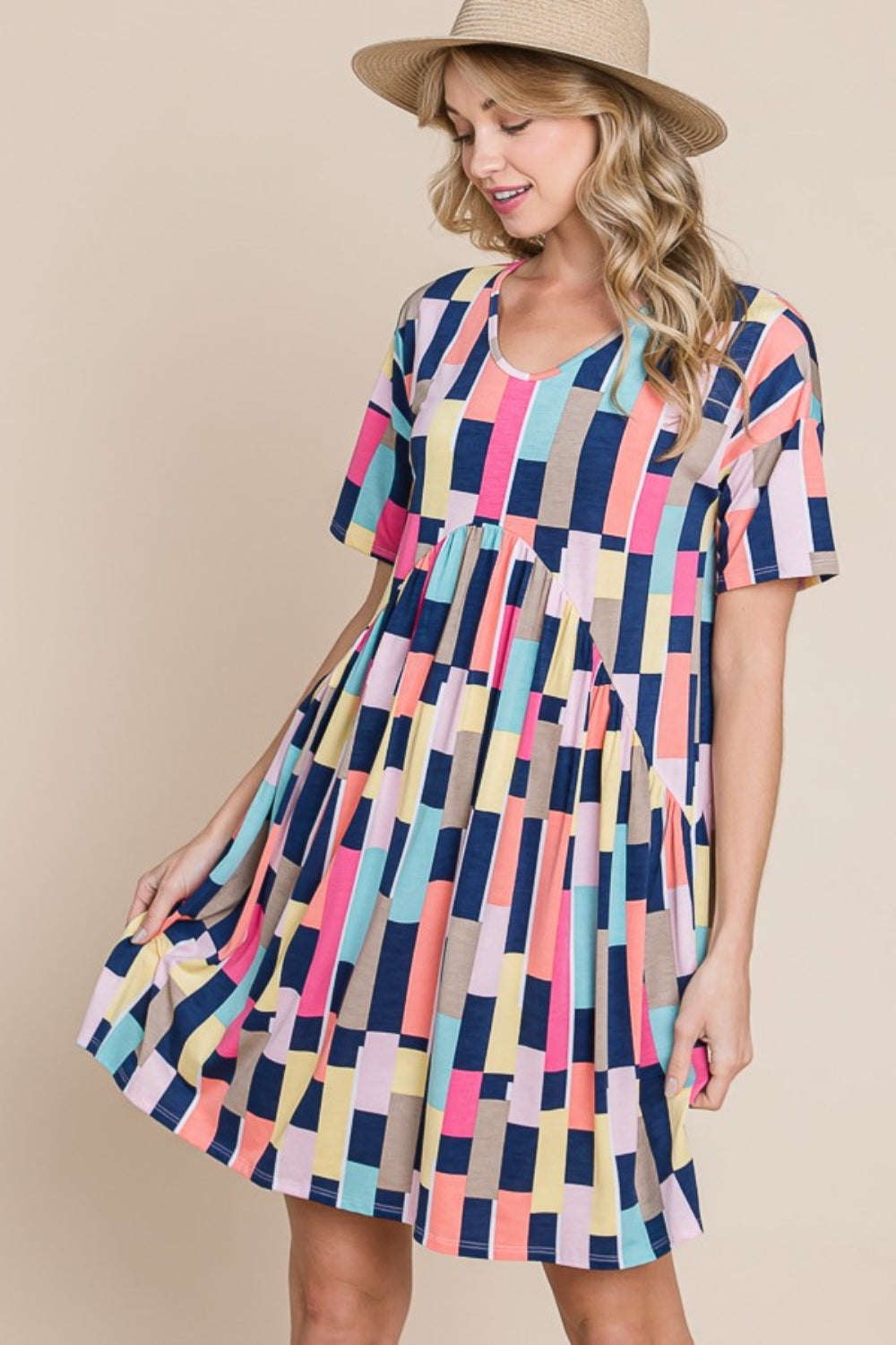 Person wearing the BOMBOM Ruched Color Block Short Sleeve Mini Dress and a straw hat, standing against a beige background, smiling.