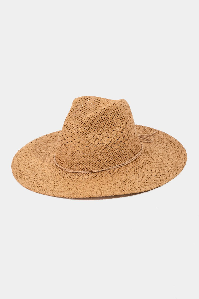 The Fame Straw Braided Sun Hat, with its wide brim and textured purple design, provides outstanding sun protection, making it an ideal summer accessory against a plain white background.