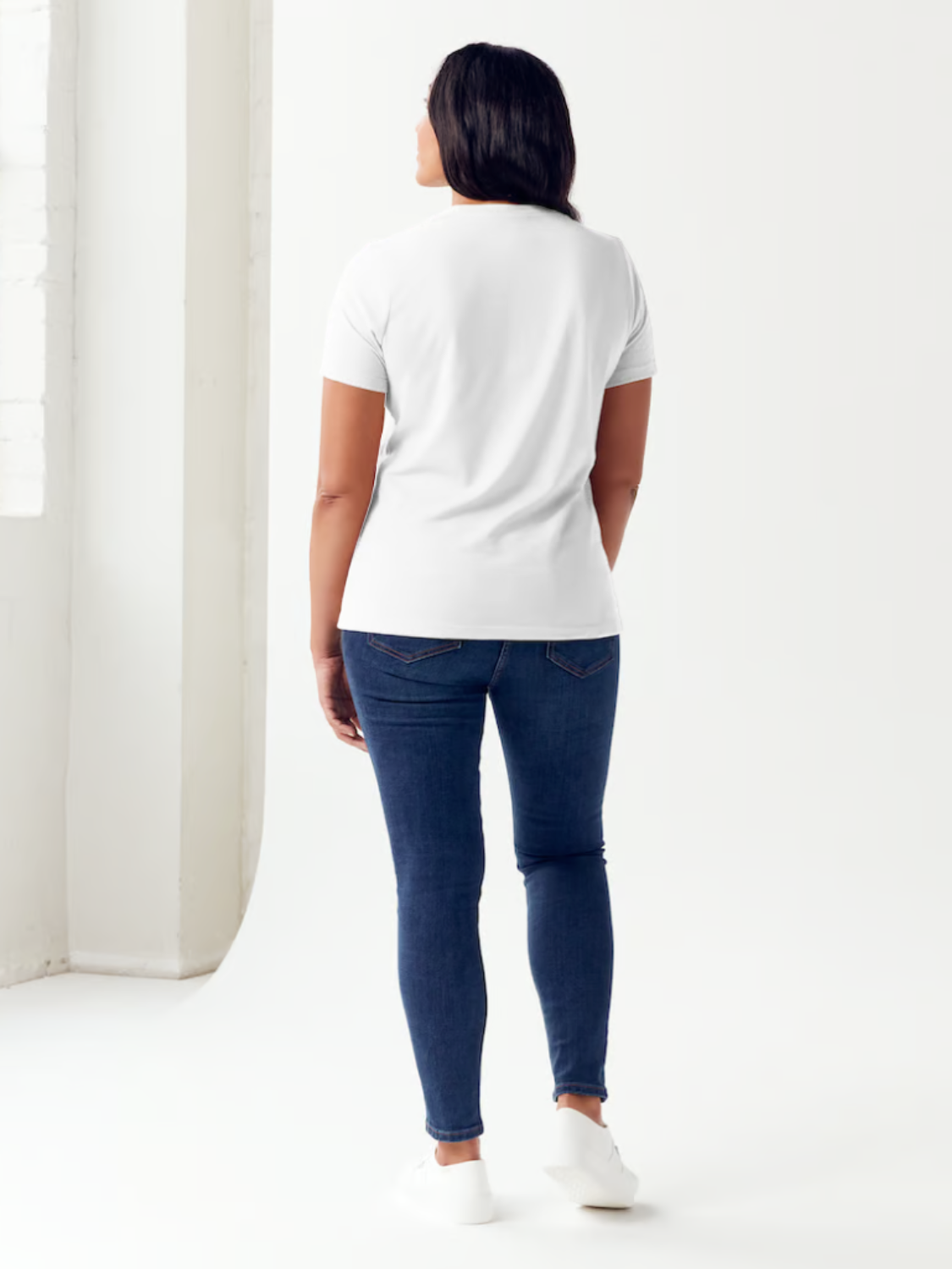 Person standing against a plain background, wearing the Simply Love Full Size VERY CLASSY VERY THOUGHTFUL Letter Graphic Short Sleeve Tubular T-Shirt made from white ringspun combed cotton.