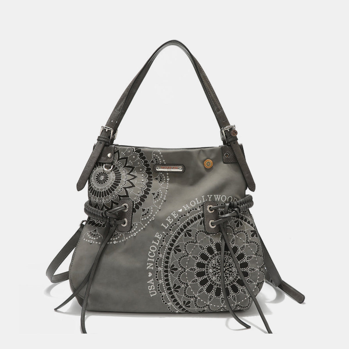 The Nicole Lee USA Side Braided Tassel Inlaid Rhinestone Embroidery Hobo Bag features intricately designed white mandala patterns on brown vegan leather, along with "Nicole Lee Hollywood USA" text. It includes top handles and decorative braided accents, as well as adjustable dual shoulder straps for added versatility.