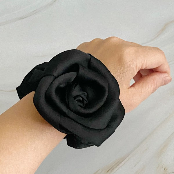Four high-quality Art Of Work Satin Rose Scrunchies in black, pink, green, and cream arranged on a marble surface.