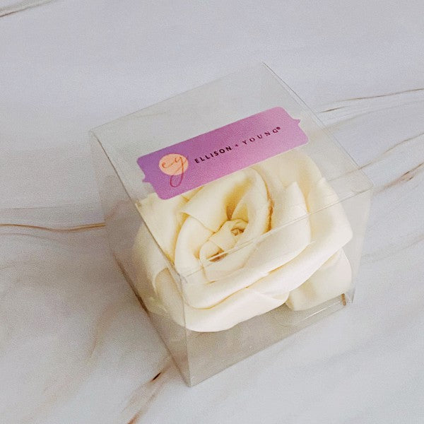 Four high-quality Art Of Work Satin Rose Scrunchies in black, pink, green, and cream arranged on a marble surface.