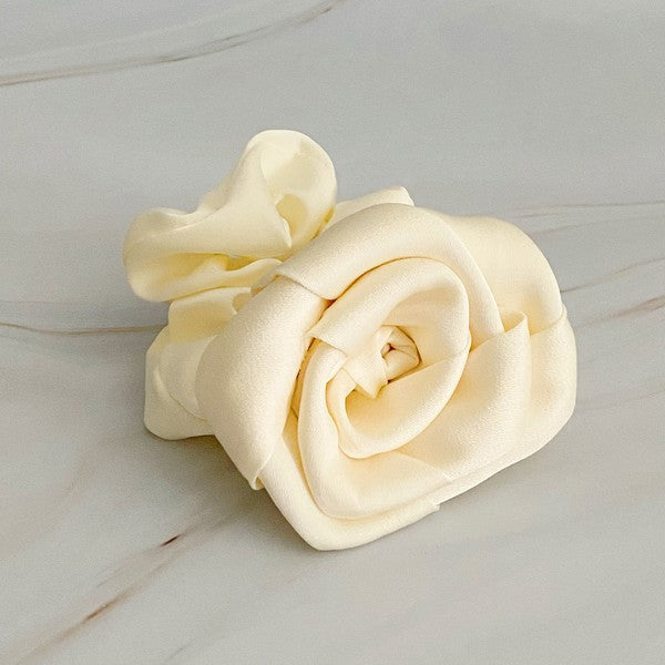 Four high-quality Art Of Work Satin Rose Scrunchies in black, pink, green, and cream arranged on a marble surface.