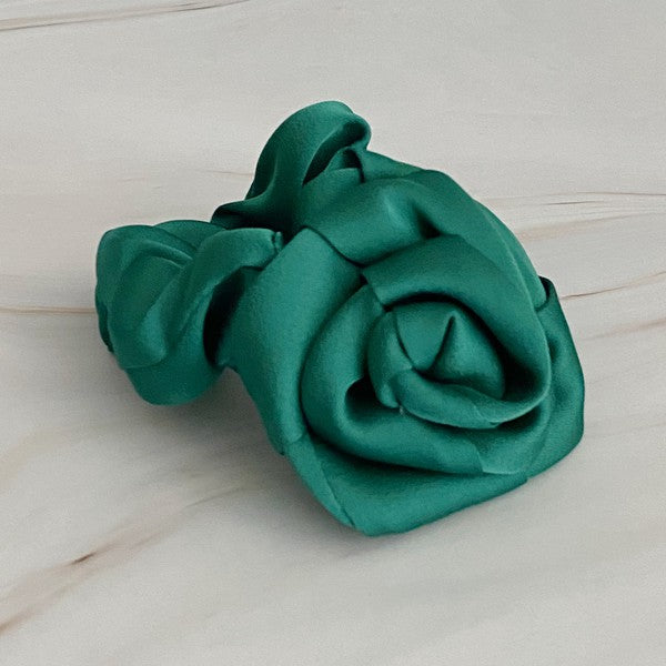Four high-quality Art Of Work Satin Rose Scrunchies in black, pink, green, and cream arranged on a marble surface.
