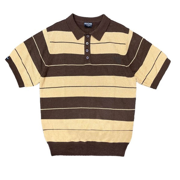 The Charlie Brown Shirt Short Sleeve Polo is a short-sleeve, polo-style shirt adorned with horizontal blue and light blue stripes. It features a buttoned collar, ribbed hem, and sleeve cuffs. Made from 100% acrylic, this design adds a touch of 1950s nostalgia to your wardrobe, reminiscent of classic Charlie Brown polos.