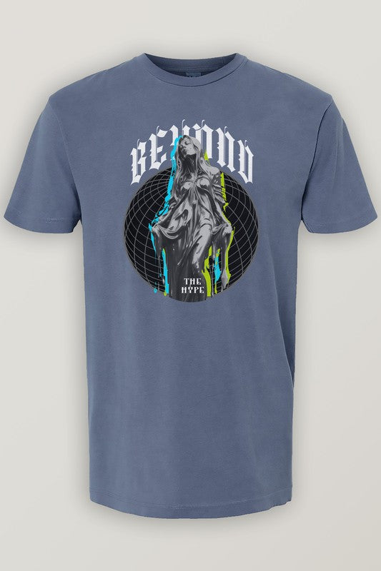 Urban Street Wear's Vintage Garment Dye Tee features a gray color with a vintage wash, showcasing a graphic of a robed figure embellished with paint splatters. The design is framed by the words "B2GOD THE HYPE" above and below an eye-catching geometric background, creating an unmistakable streetwear vibe.