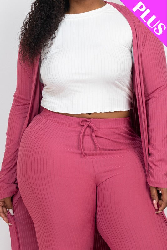 A woman wears a Plus Size Ribbed Long Cardigan & Leggings Set in beige with a white wrap top. The image features a "PLUS" label in the upper right corner.