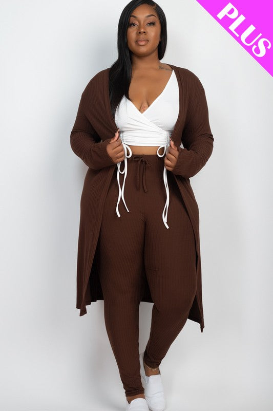 A woman wears a Plus Size Ribbed Long Cardigan & Leggings Set in beige with a white wrap top. The image features a "PLUS" label in the upper right corner.