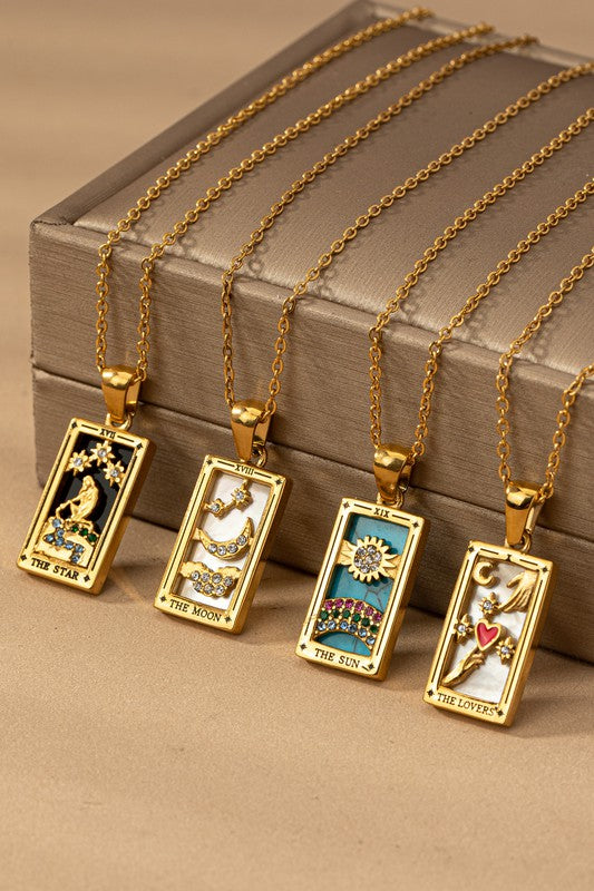 Five gold rectangular waterproof Tarot Card Natural Stone Necklaces featuring designs labeled "The Star," "The Moon," "The Sun," and "The Lovers," displayed against a beige backdrop. These exquisite necklaces include a durable PVD coating, ensuring their brilliance lasts through every wear.