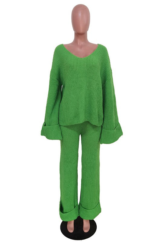 Person posing in the WOMEN FASHION 2PCS SWEATER PANTS SET, featuring a loose-fitting green knit top with bell sleeves and matching wide-leg pants.