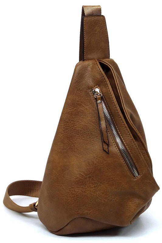 The Fashion Sling Bag Backpack, made of green faux vegan leather, showcases a single adjustable shoulder strap and two zippered compartments, displayed against a white background.