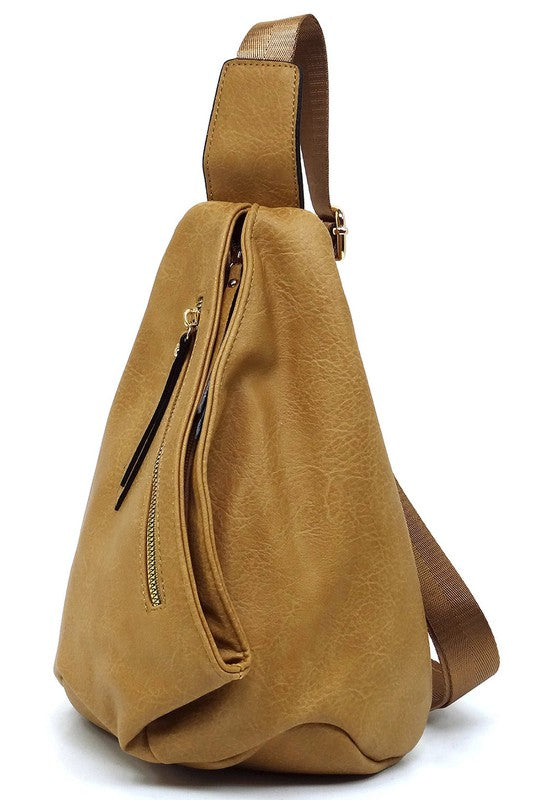 The Fashion Sling Bag Backpack, made of green faux vegan leather, showcases a single adjustable shoulder strap and two zippered compartments, displayed against a white background.