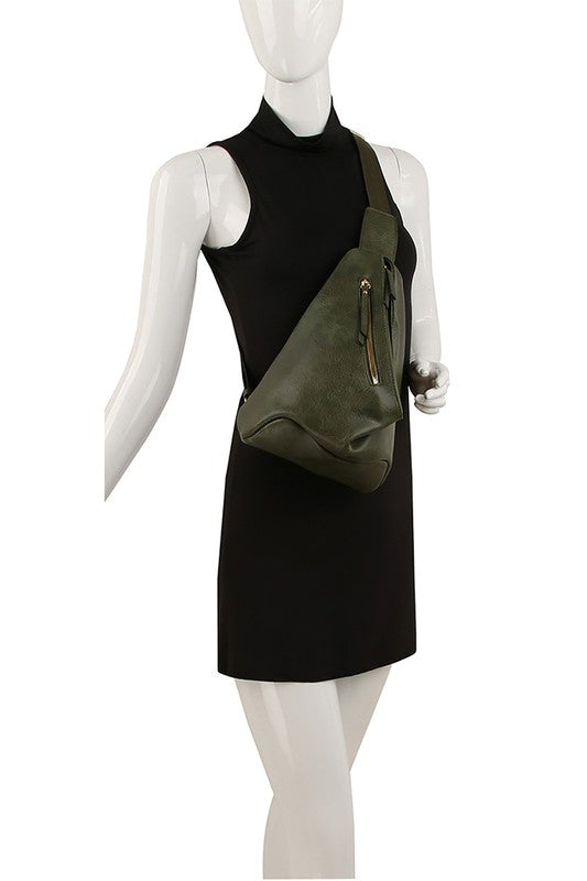 The Fashion Sling Bag Backpack, made of green faux vegan leather, showcases a single adjustable shoulder strap and two zippered compartments, displayed against a white background.