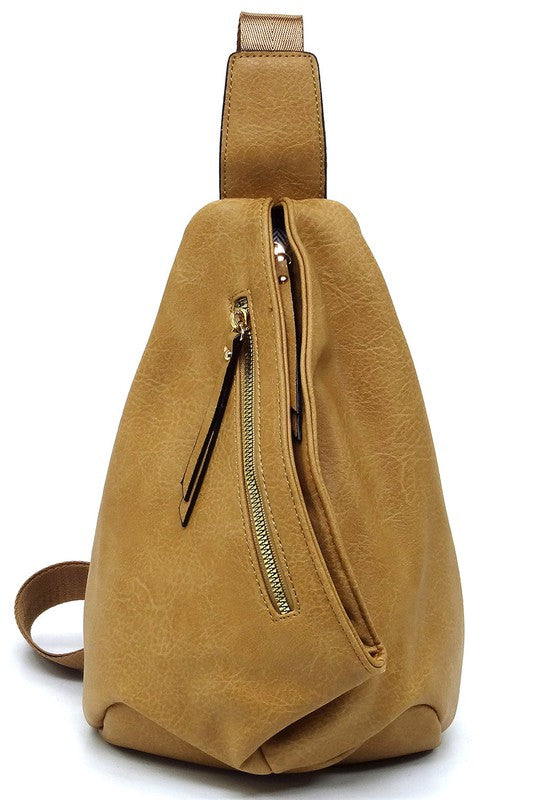 The Fashion Sling Bag Backpack, made of green faux vegan leather, showcases a single adjustable shoulder strap and two zippered compartments, displayed against a white background.