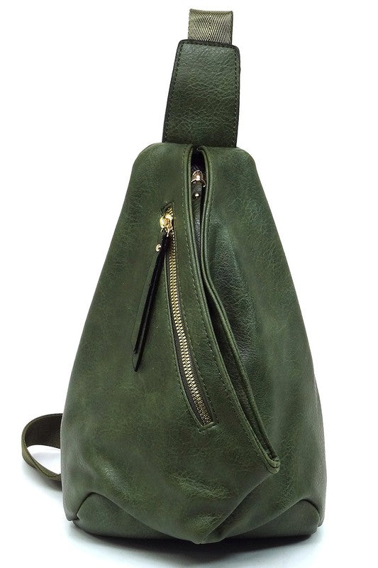 The Fashion Sling Bag Backpack, made of green faux vegan leather, showcases a single adjustable shoulder strap and two zippered compartments, displayed against a white background.