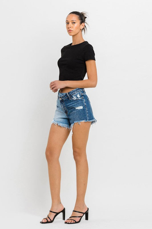 A person wearing Super High Rise Two Tone Denim Shorts and black high-heeled sandals stands against a plain background.