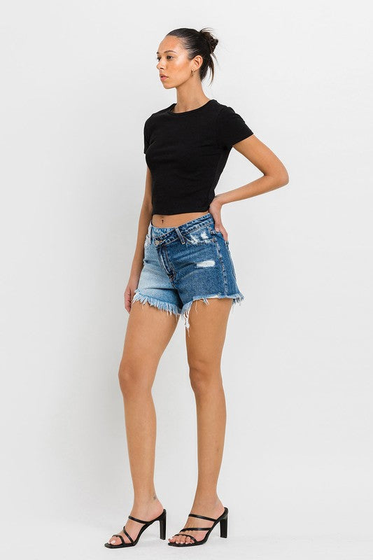 A person wearing Super High Rise Two Tone Denim Shorts and black high-heeled sandals stands against a plain background.