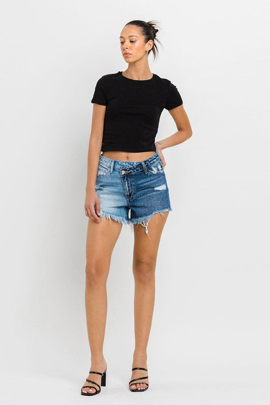 A person wearing Super High Rise Two Tone Denim Shorts and black high-heeled sandals stands against a plain background.